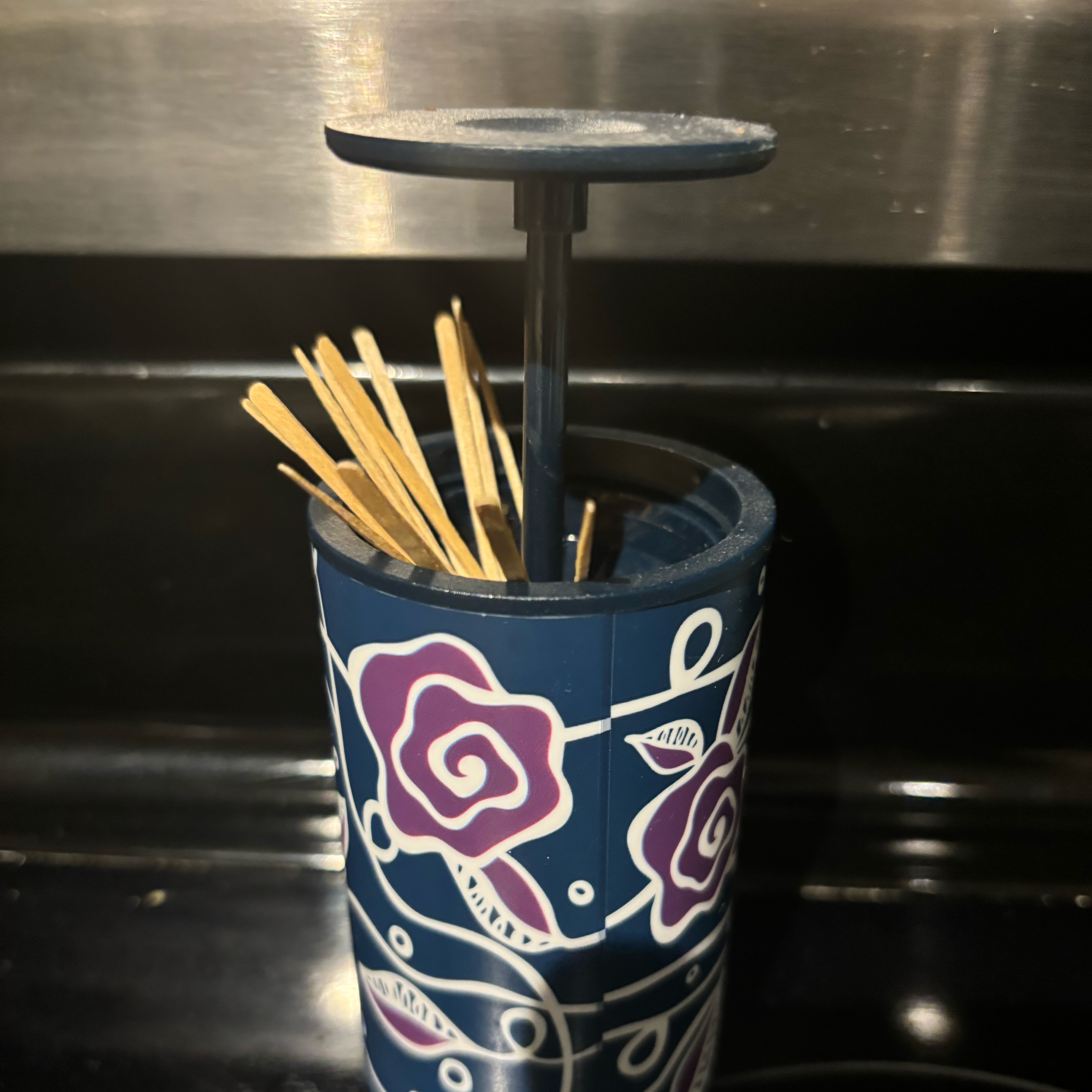 Opening and closing toothpick holder