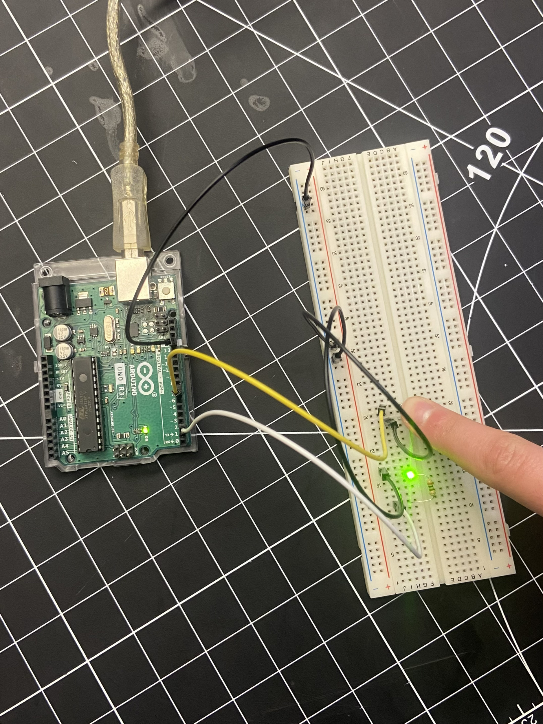 Create a circuit that not only involves a light but a button that triggers the light to go off and on.