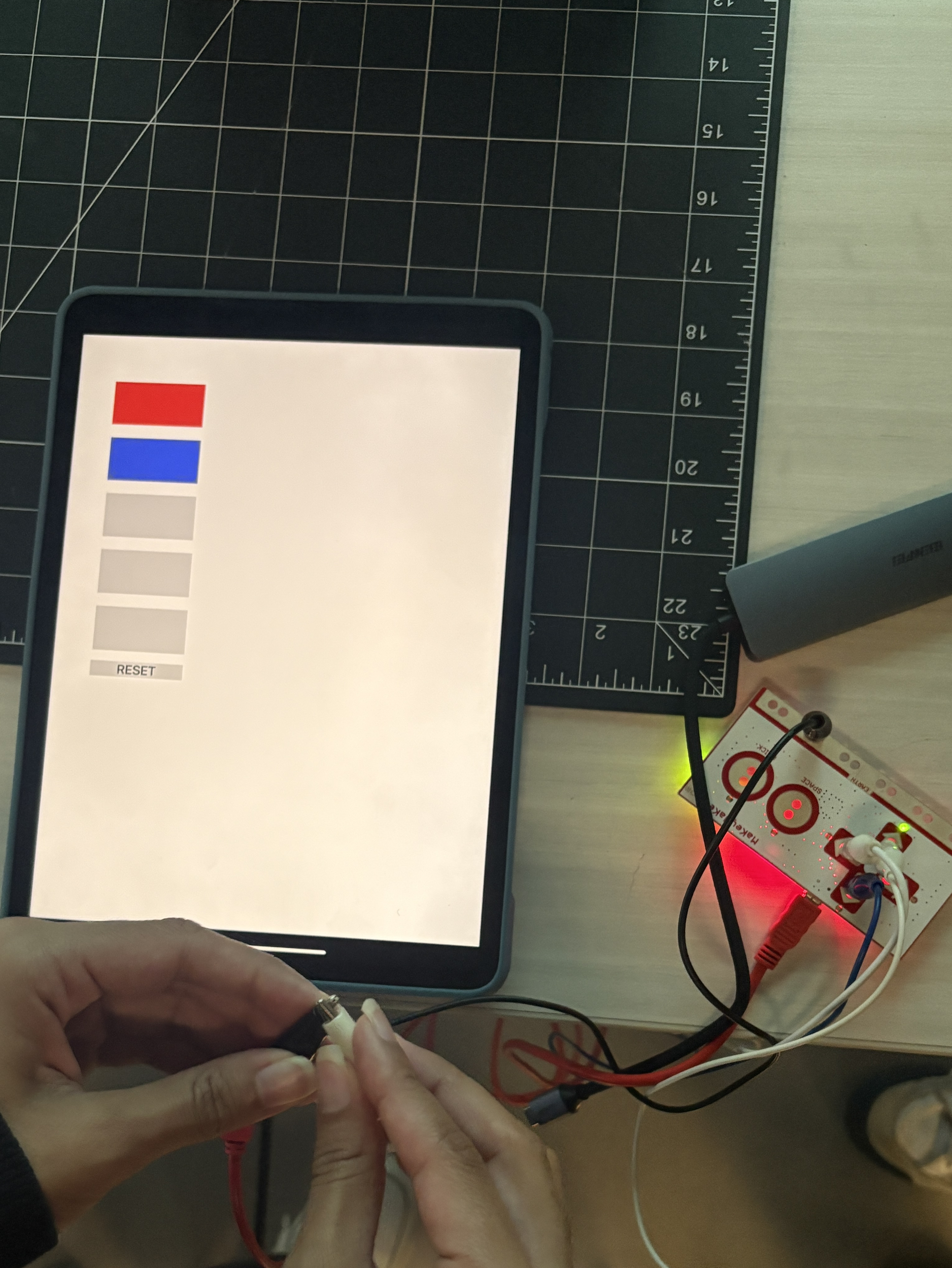 In this photo, you can see exactly what is happening that when you select one of cords to specifically touch the circuit that's connected to the earth, it will trigger a response making a specific color go off. And you can see that we were testing that here. 